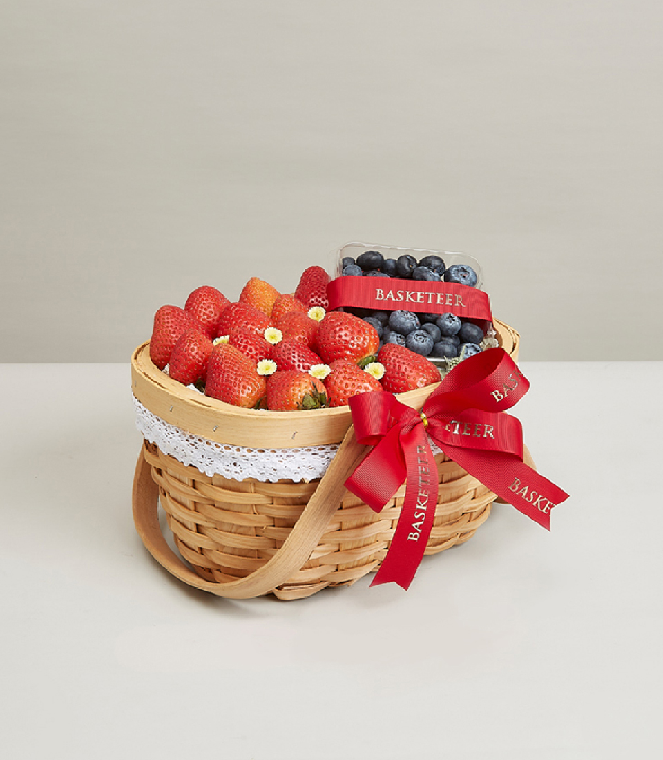 Indulge in the delightful flavors of our Berry Fruit Selection Basket. This gift features a perfect blend of fresh strawberries and juicy blueberries, totaling two fruits, elegantly presented in a rustic brown basket adorned with a charming red bow decoration. Ideal for any occasion, order now and treat your loved ones to a taste of berry bliss!