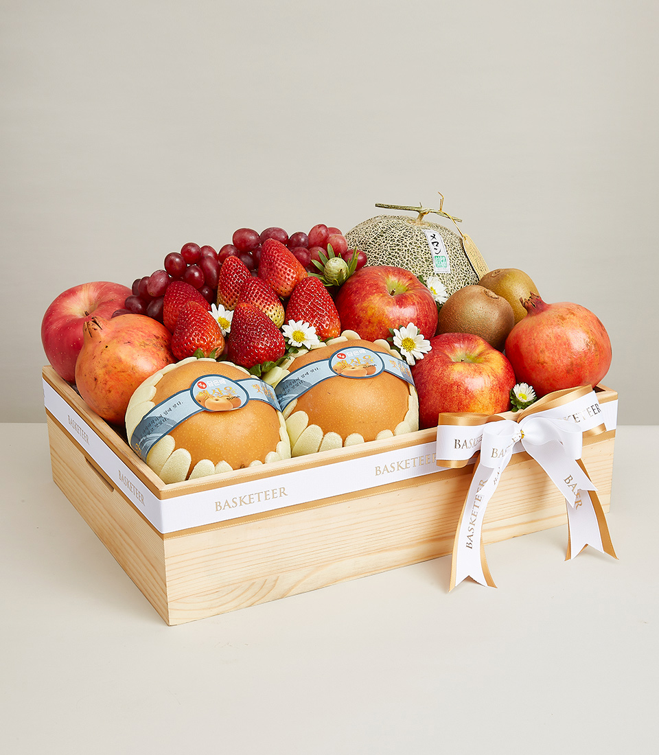 Gift boxes filled with various types of premium grade fresh fruits such as red apples, red strawberries, red grapes and many more. Decorated with an orange and white ribbon bow with the word 