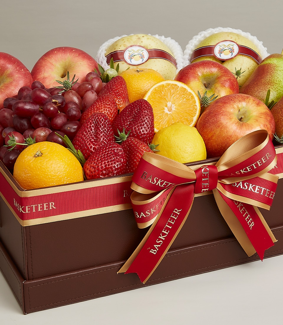 A sumptuous leather-bound basket brimming with an exquisite selection of fresh fruits: crisp apples, luscious grapes, succulent strawberries, vibrant oranges, zesty lemons, and two elegantly wrapped Asian pears. The basket is artfully adorned with a luxurious red ribbon inscribed with 