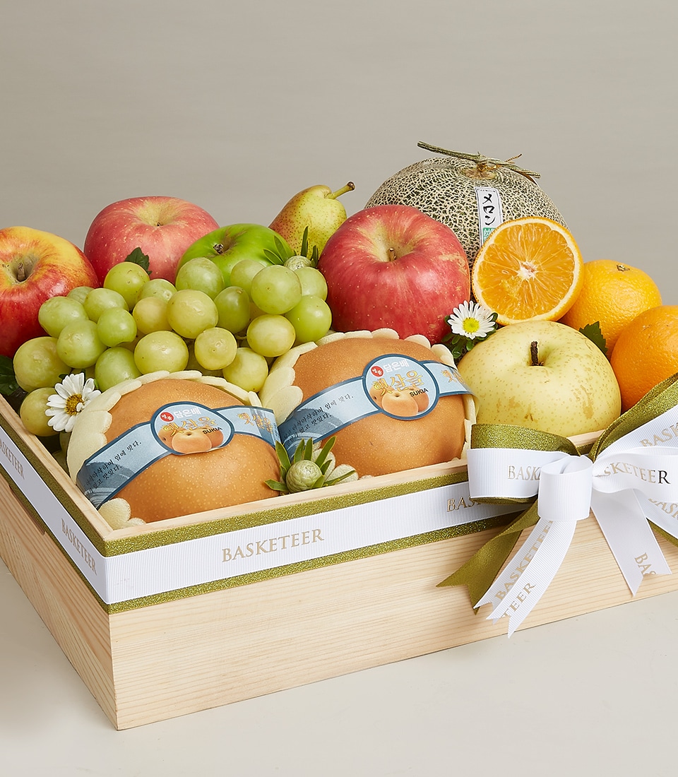 A luxurious wooden crate overflowing with an exquisite assortment of fresh fruits, featuring crisp apples, luscious grapes, succulent pears, vibrant oranges, and juicy melons, all complemented by a bouquet of elegant flowers. Adorned with a pristine white ribbon emblazoned with the 