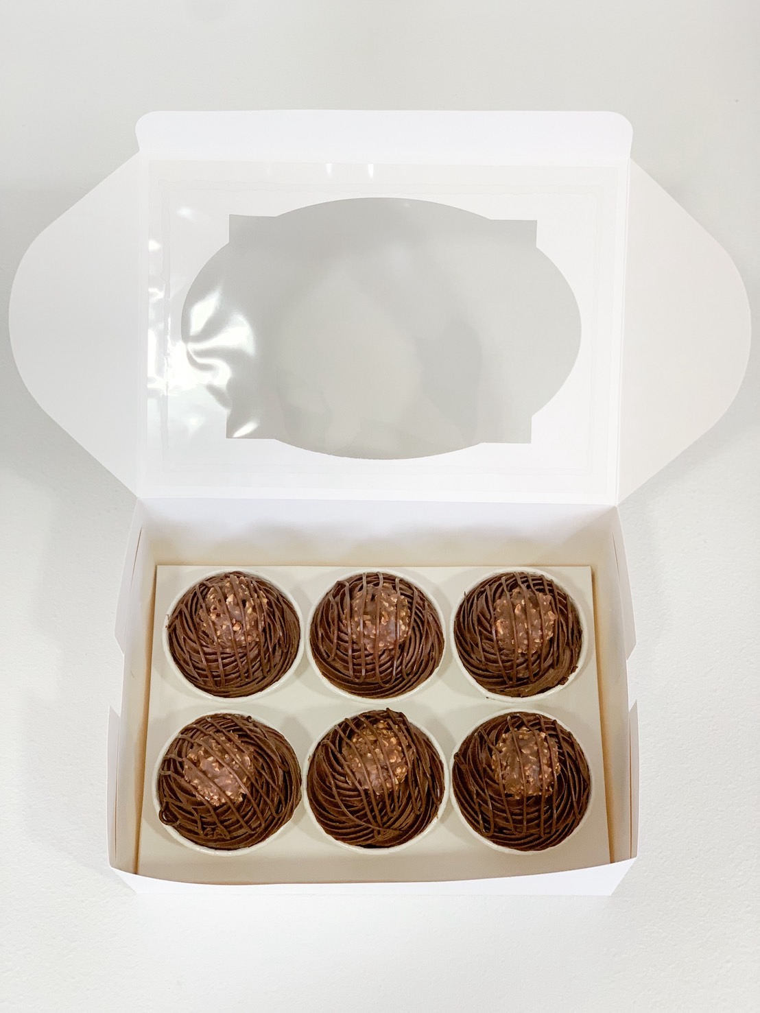 Box of six premium chocolate truffles drizzled with dark chocolate.