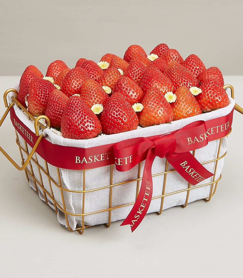 A sophisticated rectangular wire basket adorned with a red ribbon elegantly inscribed with 
