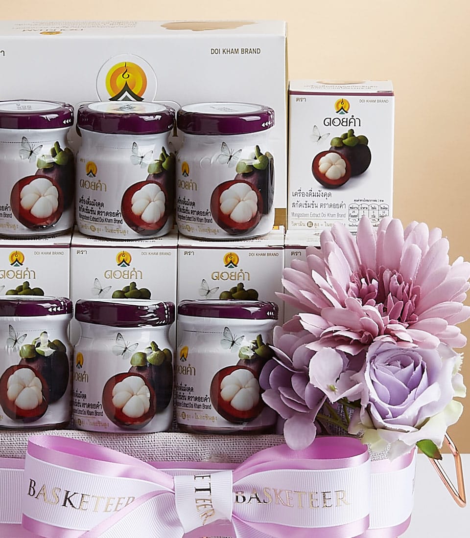 A luxurious gift arrangement showcasing a selection of Doi Kham brand mangosteen products, each elegantly presented in jars adorned with vibrant mangosteen imagery on the labels. The ensemble is gracefully tied with a sophisticated pink ribbon, proudly bearing the 