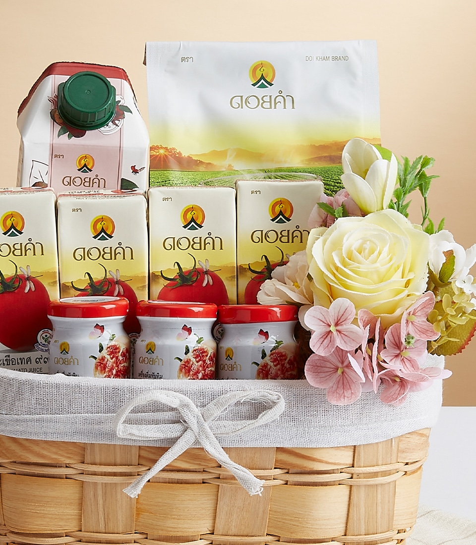 A luxurious wicker basket elegantly filled with an assortment of premium beverages and gourmet canned delicacies, thoughtfully arranged. The Basket is adorned with delicate yellow and white blossoms, enhancing its opulent appeal. A sophisticated ribbon bearing the Basketeer logo graces the arrangement, signifying both quality and artistry. The packaging showcases a refined logo depicting a mountainous landscape, evoking feelings of serene grandeur and culinary adventure from the esteemed Basketeer brand.
