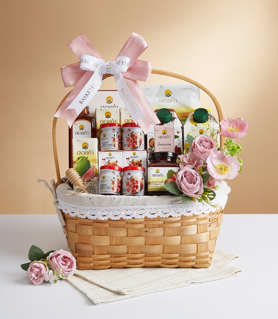 A luxurious wicker basket brimming with exquisite Aojen products, elegantly adorned with a delicate pink bow emblazoned with 