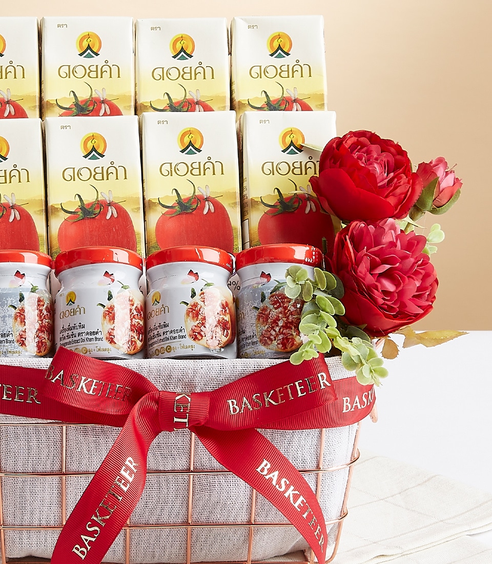 A luxurious gift basket brimming with an assortment of premium tomato products, elegantly presented in opulent cartons and charming jars. The baskesphere is beautifully enhanced by vibrant red flowers and lush green leaves, exuding a sense of abundance and sophistication. A striking red ribbon emblazoned with the prestigious 