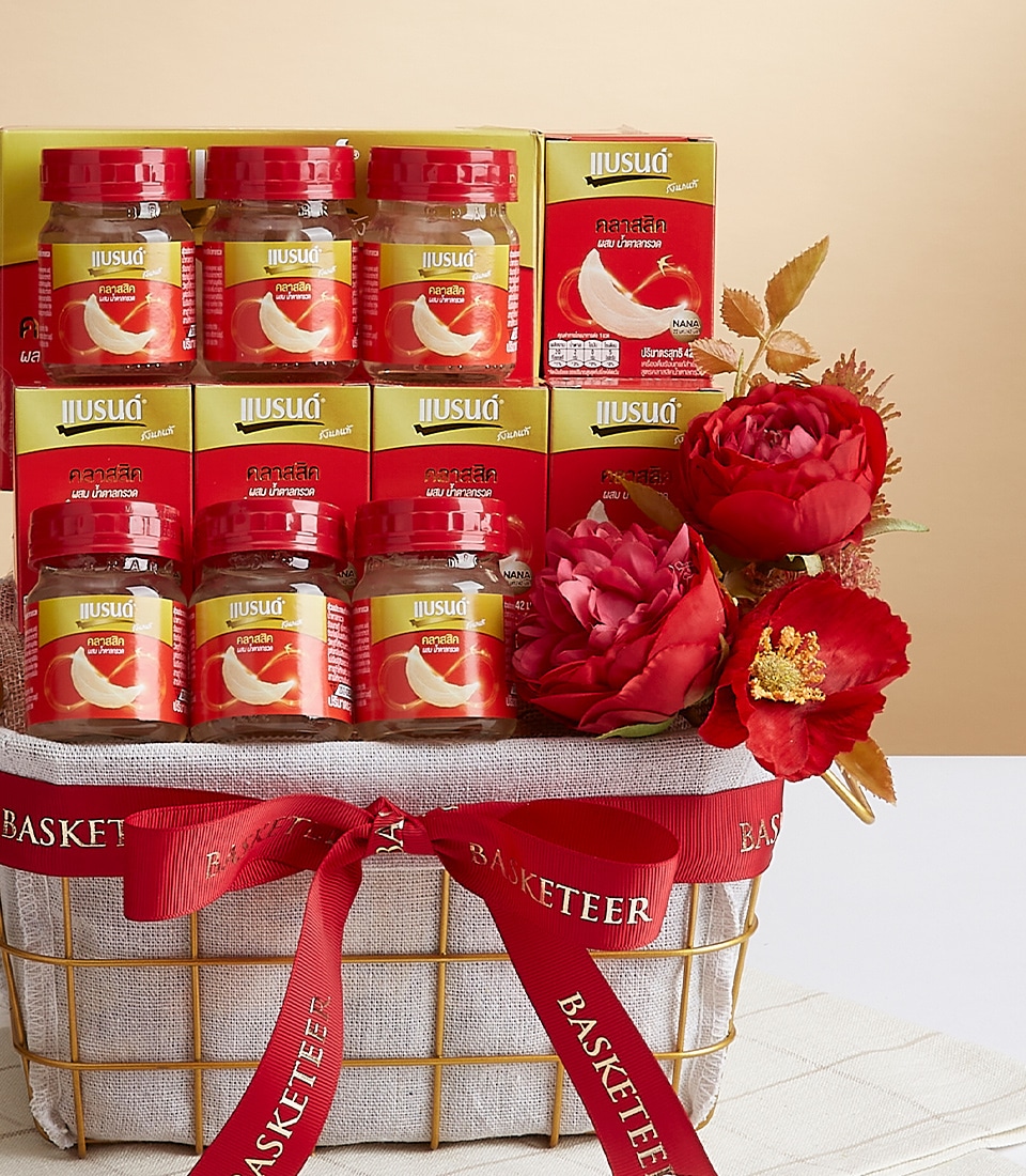 A luxurious gold wire basket adorned with an elegant red ribbon bearing the 