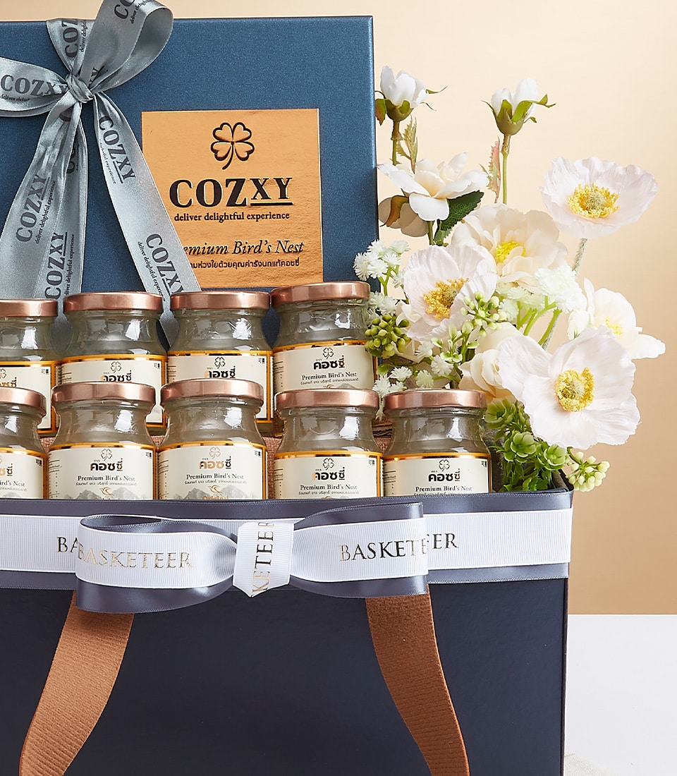 A luxurious gift basket elegantly presented with jars of premium bird's nest, adorned with an exquisite light blue ribbon inscribed with 