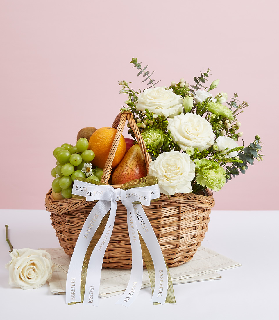 Mixed Fresh Fruits With White Tone Flowers In The Basket With a Bow
