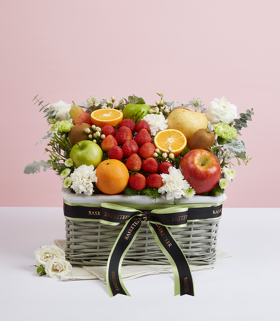 Mixed Fresh Fruits With White Flower Tone In The Gray Basket With a Bow