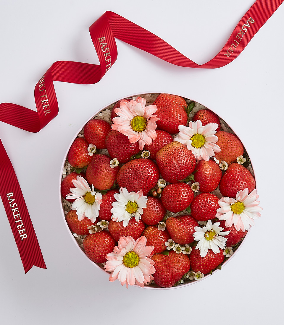 Strawberries Decorated With Flowers Gift In The Round Box With a Red Bow