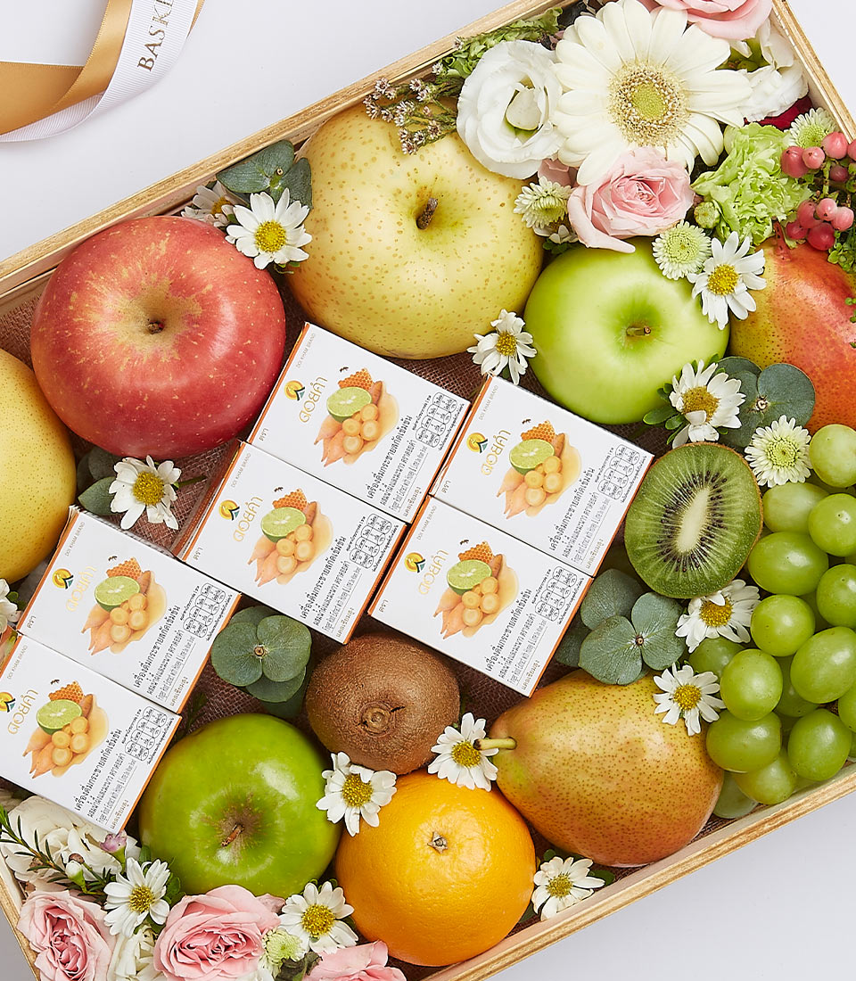 An elegant wooden tray, showcasing Basketeer’s Exquisite Fruit Collection Box, overflowing with a curated selection of premium fruits and delicate flowers. The luxurious bounty features crisp apples, vibrant oranges, succulent kiwi, juicy pears, and luscious grapes. The arrangement is artistically complemented by dainty white and pink flowers. Nestled within the display are multiple small rectangular boxes of delectable snacks, each adorned with the distinguished Basketeer logo, adding an extra touch of sophistication to this opulent ensemble.