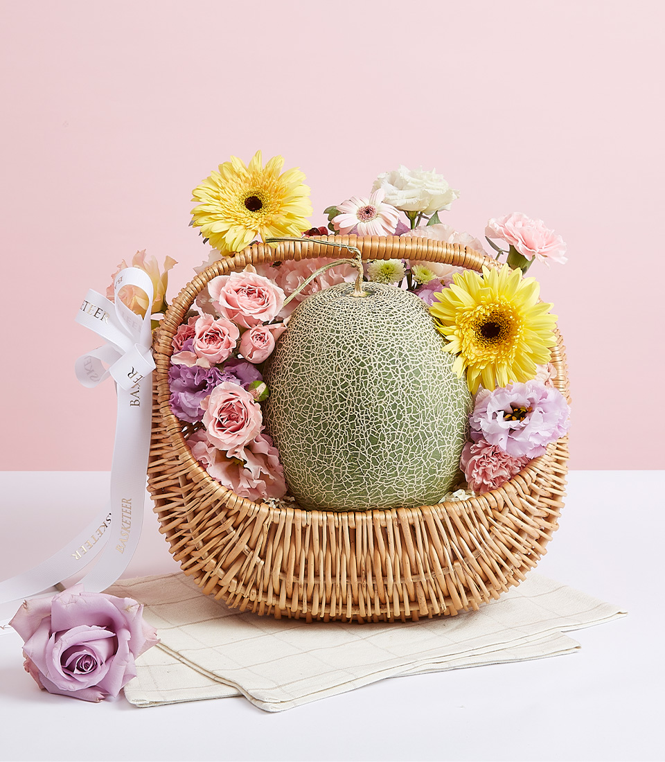 Melon Fruit With Bloom Flowers In Basket