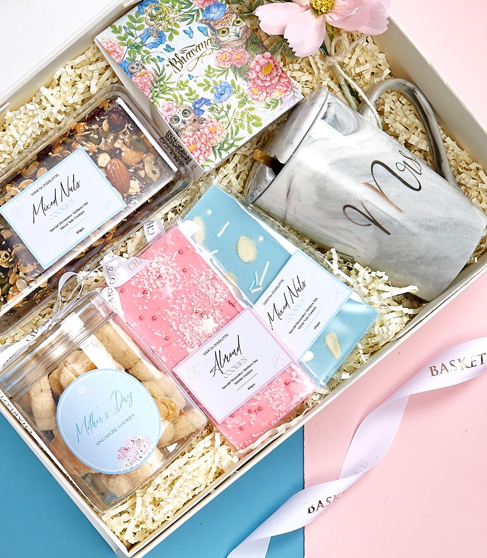 A luxurious gift box adorned with the Basketeer emblem, containing an elegant marble-patterned mug inscribed with 