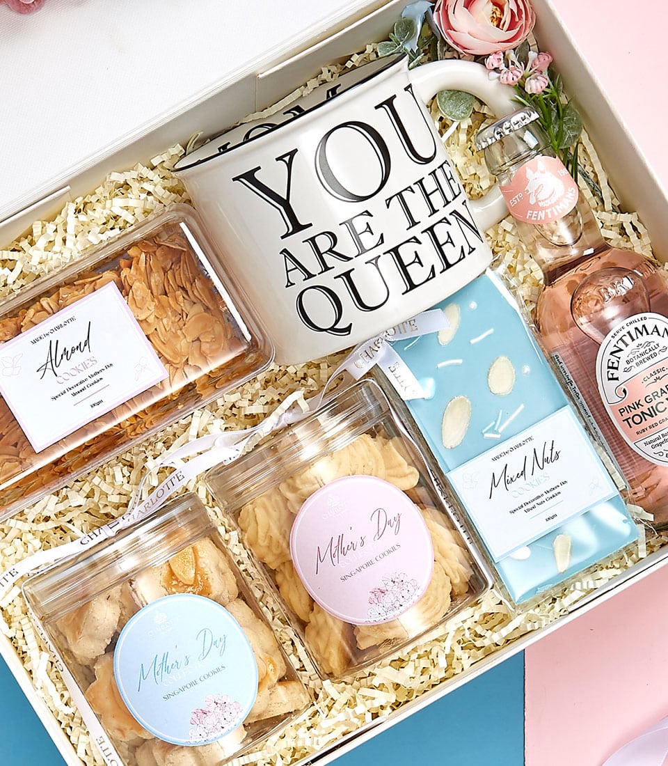 A luxurious gift box curated by Basketeer, showcasing an elegant white mug adorned with the regal inscription 