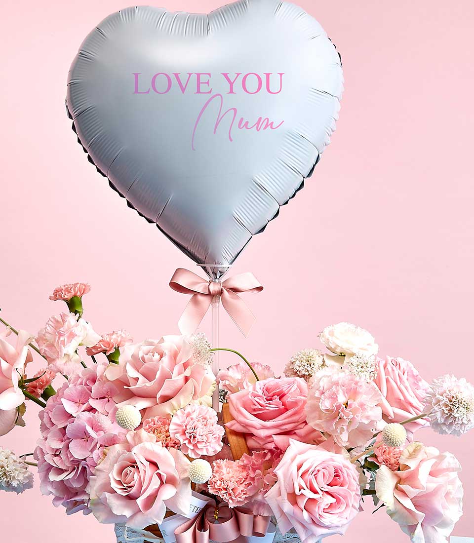 A heart-shaped silver balloon adorned with the elegant words 