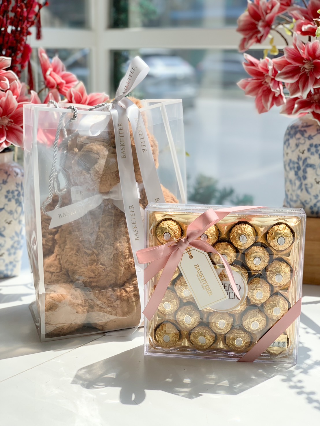 A luxury gift set featuring a soft teddy bear and a box of Ferrero Rocher chocolates, elegantly arranged with a ribbon, perfect for romantic and special occasions.
