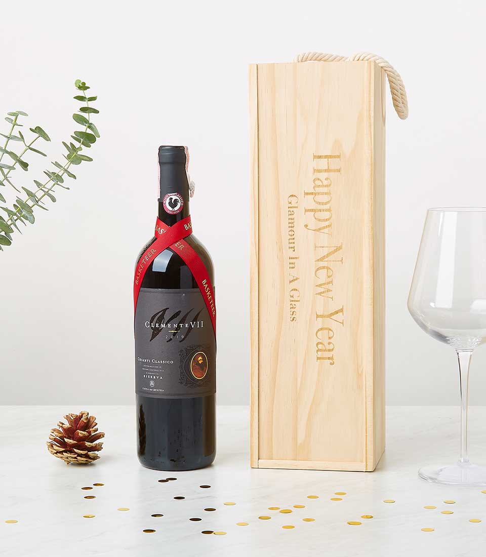A sumptuous bottle of red wine adorned with a luxurious ribbon rests elegantly on a pristine white surface, accompanied by an exquisite wooden gift box embellished with the sophisticated 