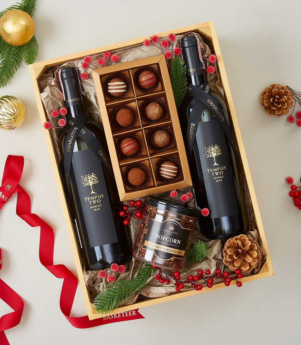A lavish gift basket exudes luxury with its carefully curated selection, featuring two elegant bottles of 