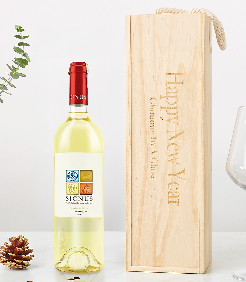 A bottle of Signus white wine (2020 vintage) displayed alongside a custom-engraved wooden wine box reading 