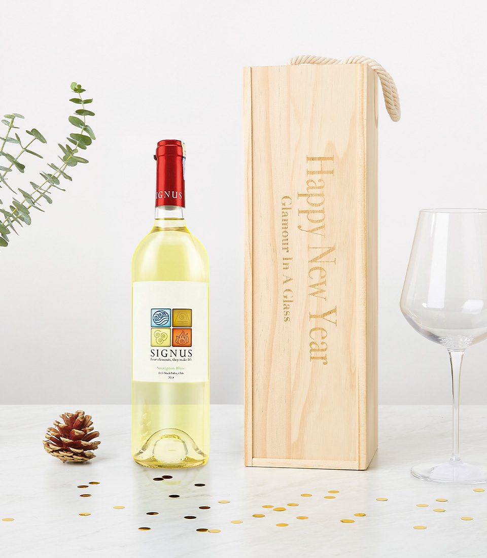 A bottle of Signus white wine (2020 vintage) displayed alongside a custom-engraved wooden wine box reading 