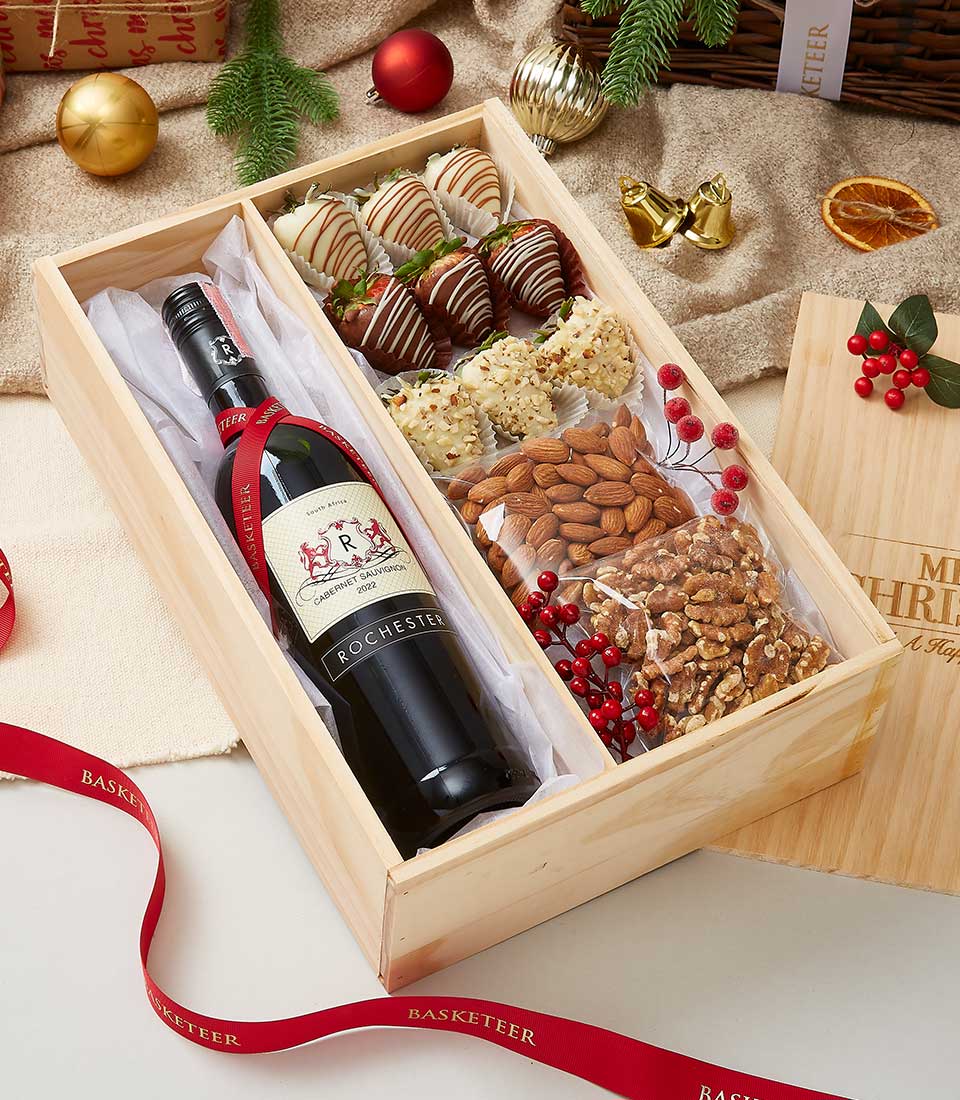 wine, chocolate-covered strawberries, and nuts in a wooden gift box: