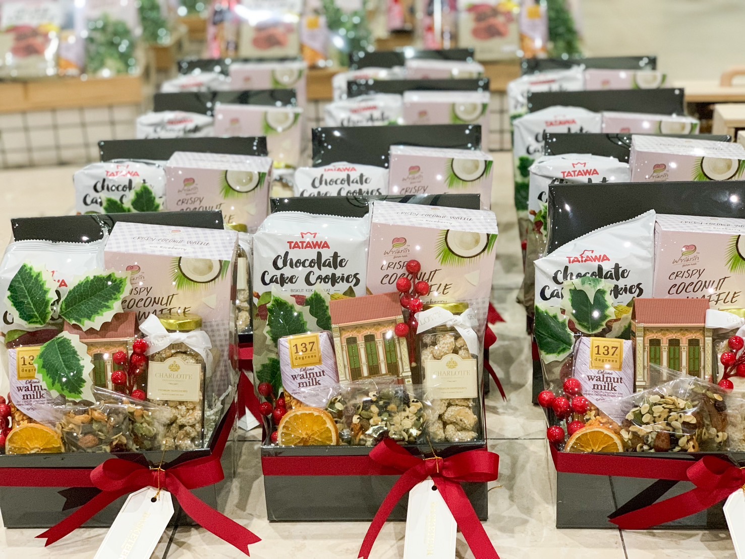 Gift set with crispy coconut waffles, chocolate cake cookies, mixed nuts, and festive decorations by Basketeer.