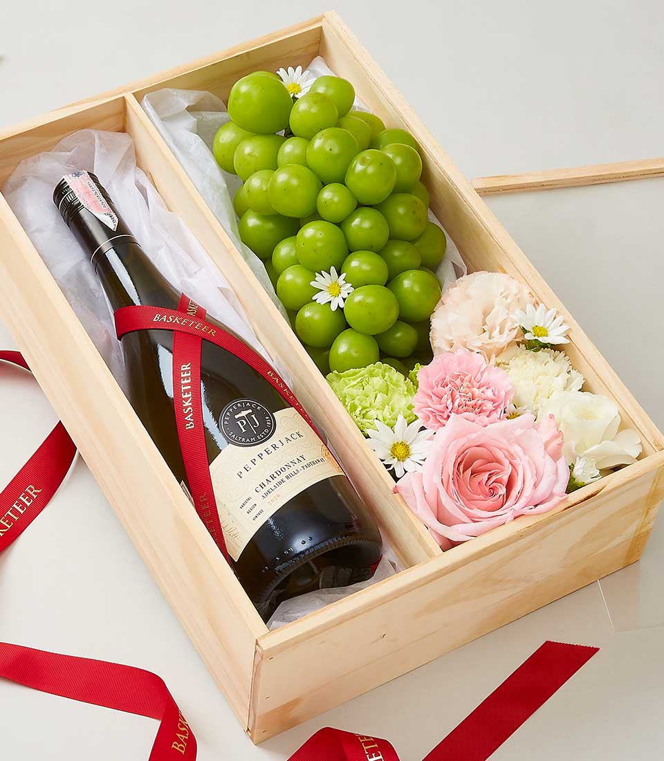 A luxurious wooden gift box elegantly showcases a premium bottle of wine, tastefully adorned with a red ribbon featuring the 
