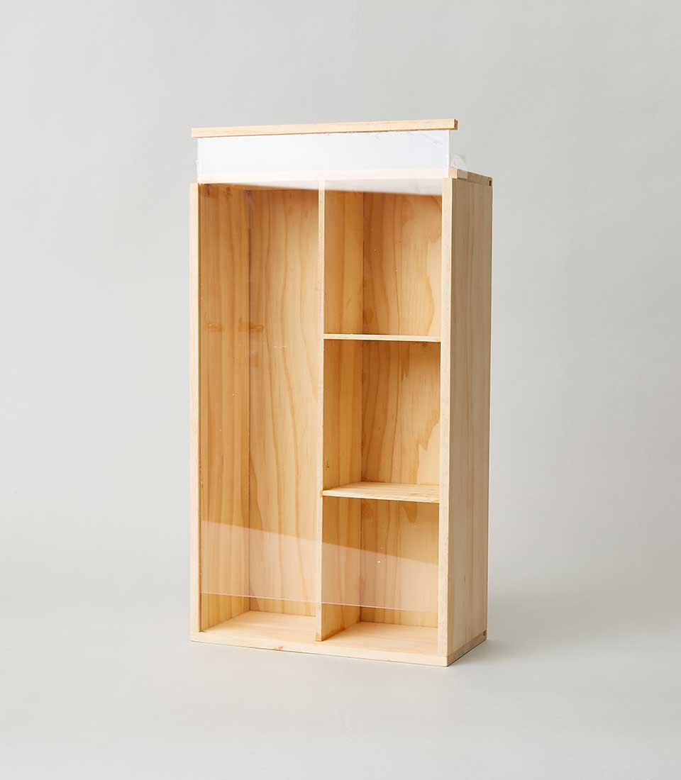 A sophisticated wooden storage unit by Basketeer, exquisitely crafted with five elegant rectangular compartments of varying sizes. This luxurious piece, featuring a rich natural wood finish, effortlessly stands out against a pristine, light-colored backdrop. The subtle yet prominent Basketeer logo etched on the compartments hints at the brand's commitment to quality and style.