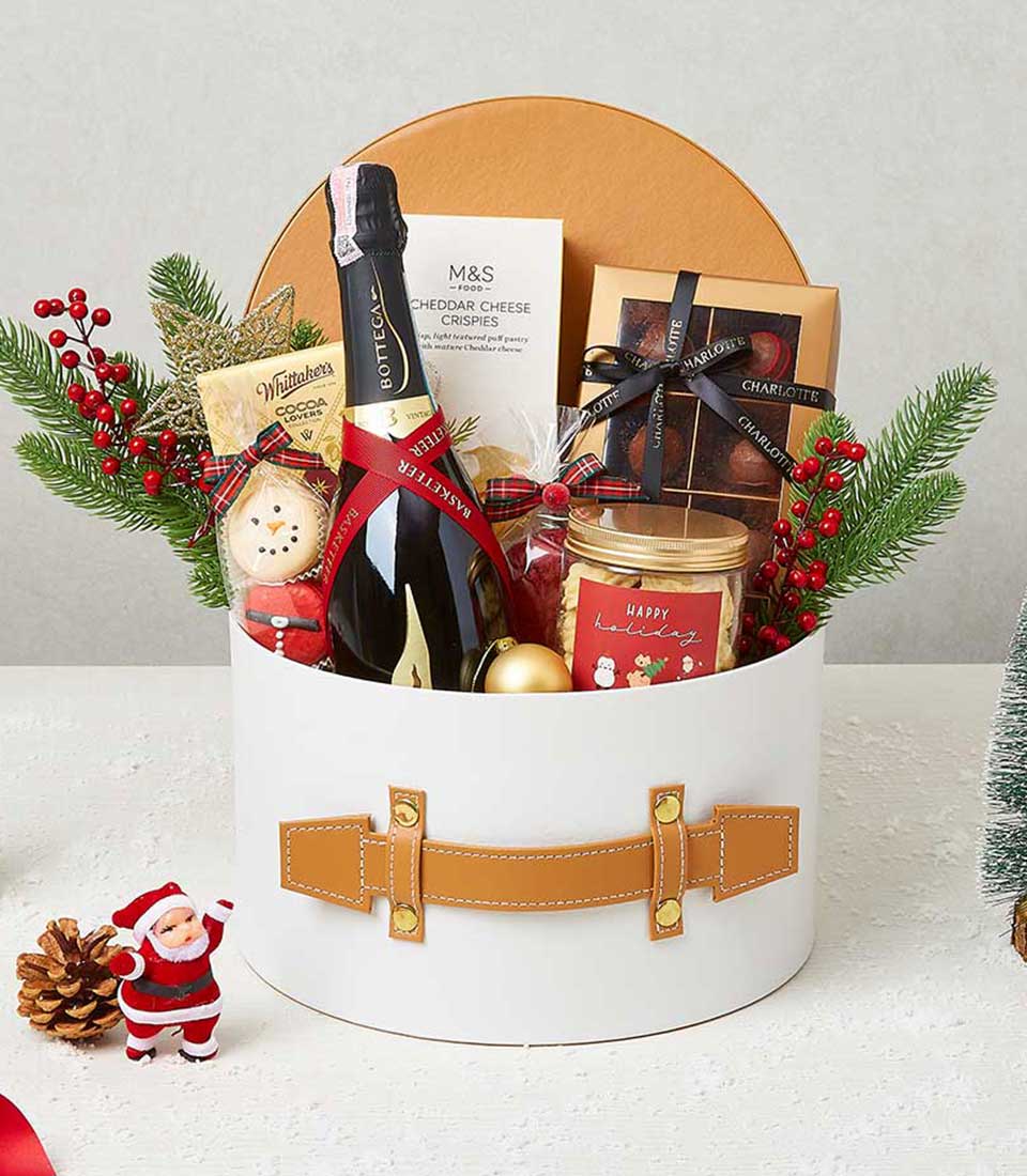 Luxury Christmas gift basket with festive cookies, cocoa, cheese crisps, and holiday treats for celebrations.