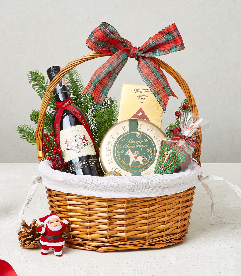 Festive Christmas gift basket featuring cocoa, holiday cookies, and decorative accents for seasonal celebrations.