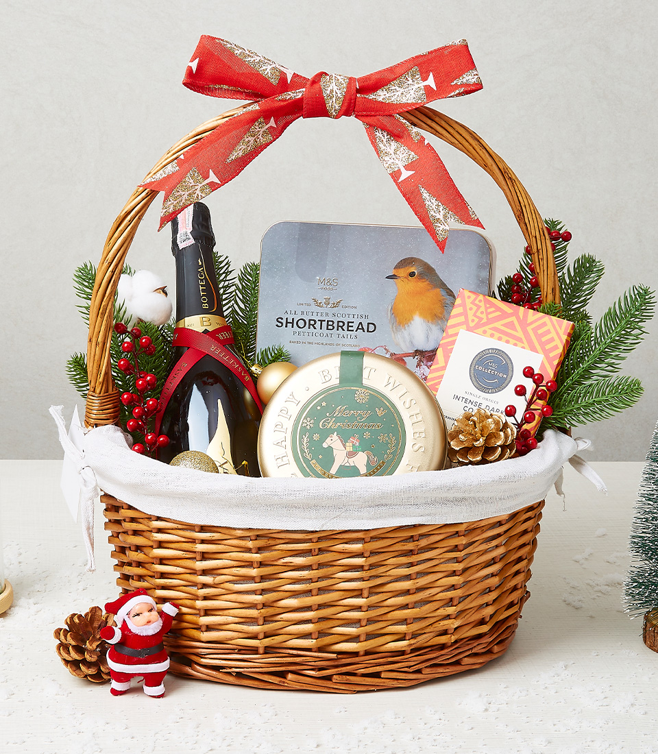 Festive Christmas gift basket with chocolates, biscuits, and holiday-themed goodies in a beautifully wrapped wicker basket.