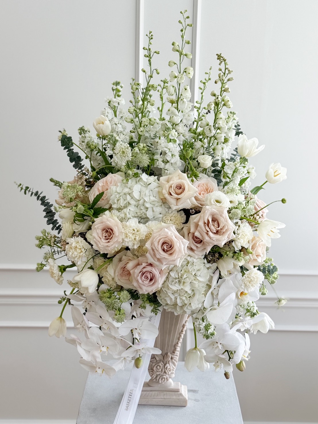 Luxury ivory vase arrangement with blush roses, white hydrangeas, tulips, delphinium, orchids and eucalyptus in classic urn, Bangkok delivery