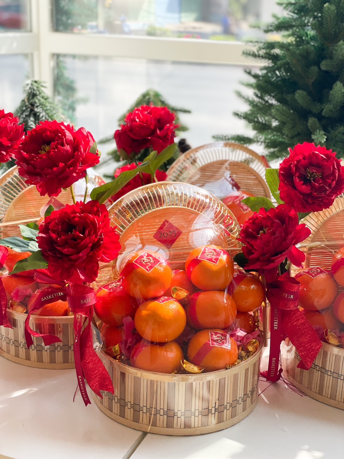 Close-up of a Chinese New Year orange baskets with red peonies, gold accents, and festive decorations, perfect for gifting and celebrations.