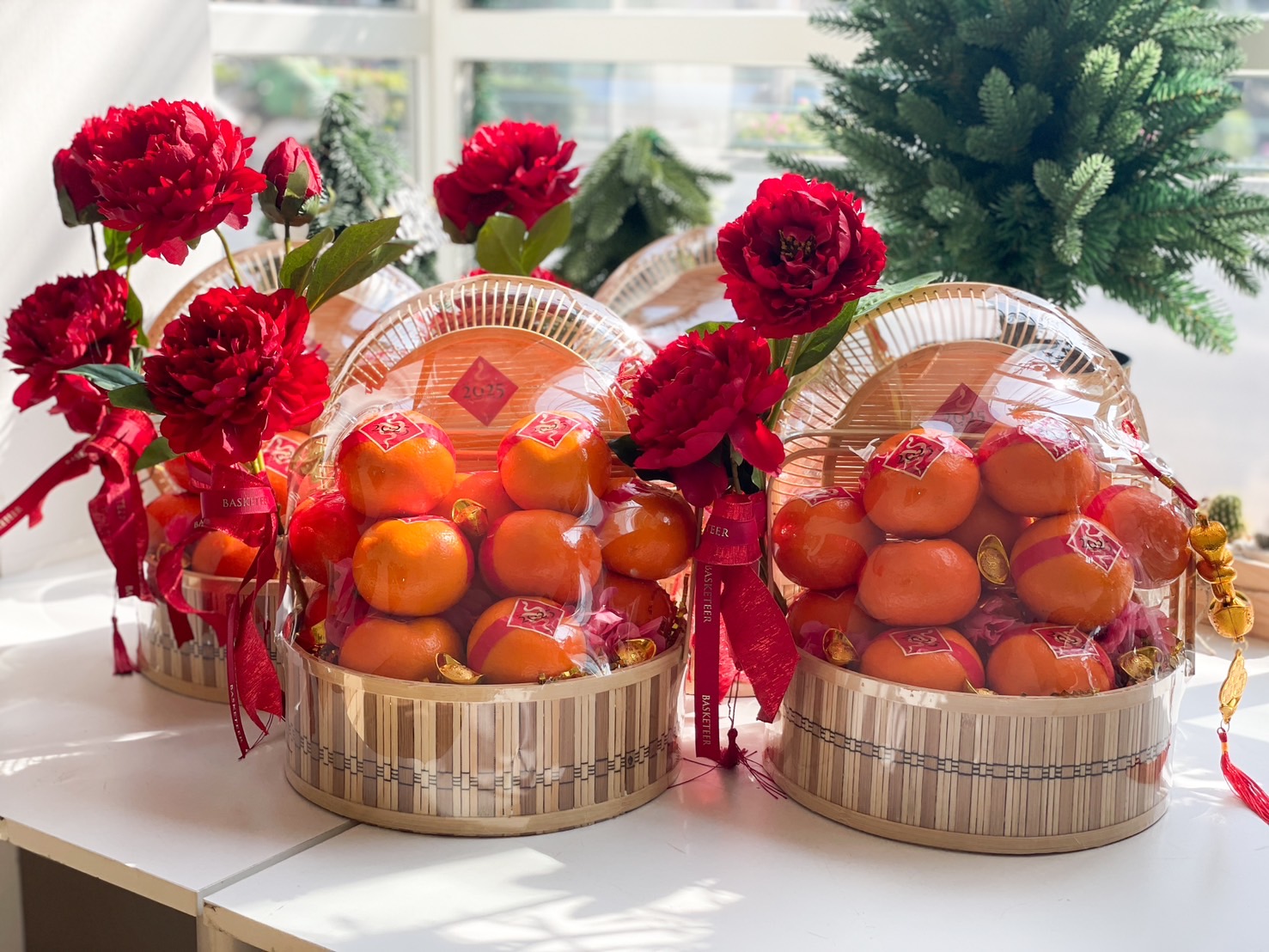 Chinese New Year orange baskets with red peonies, gold accents, and festive decorations, perfect for gifting and celebrations.