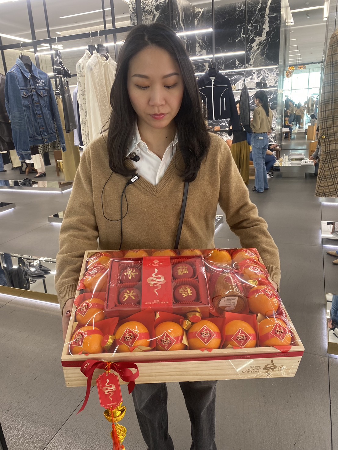 Chinese New Year gift basket with premium mandarin oranges, festive treats, and elegant red and gold decorations.