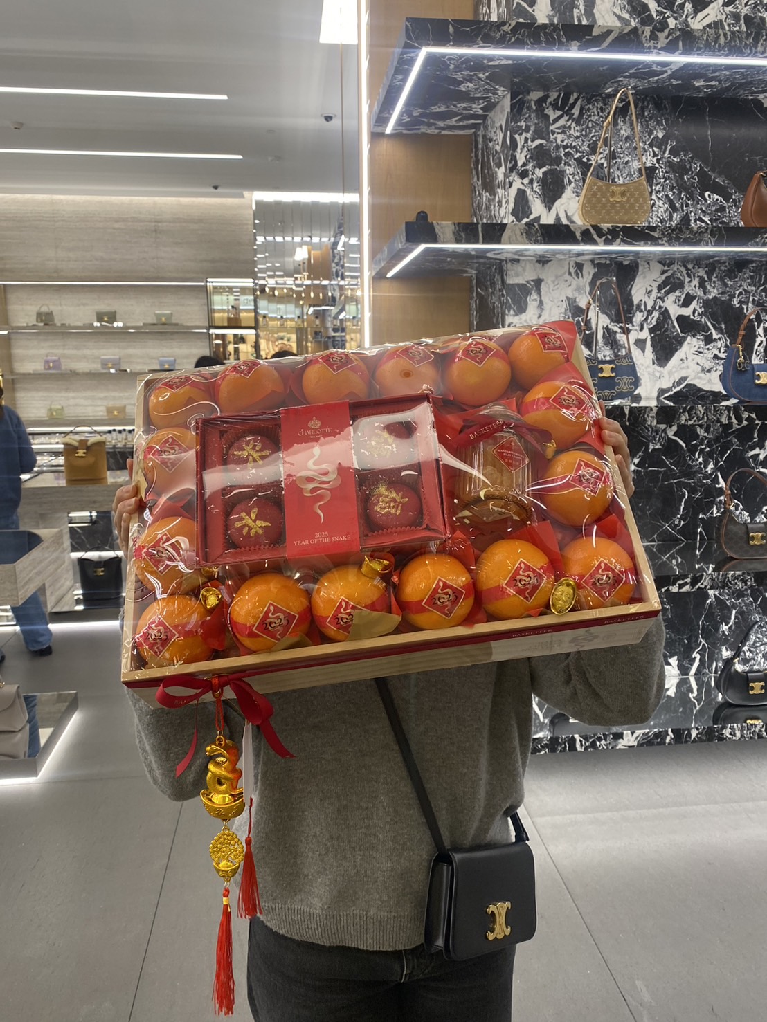 Chinese New Year gift basket with premium mandarin oranges, festive treats, and red & gold decorations for good fortune.