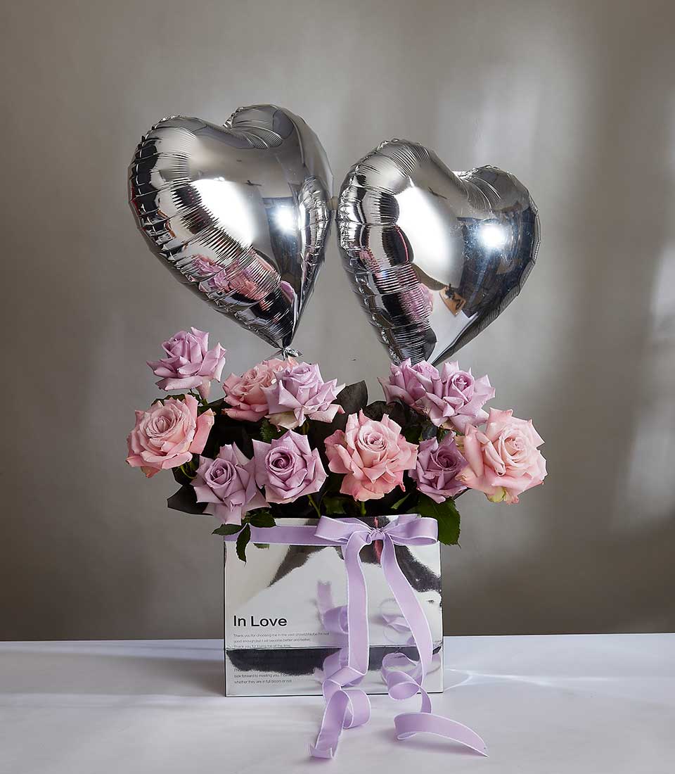 Indulge in the Sweet Rose Harmony Collection Gift featuring a stunning purple roses bouquet paired with a graceful gray heart balloon. Ideal for birthdays, Valentine's Day, or any special occasion, this charming gift exudes elegance and romance. Order now and make their day unforgettable!
