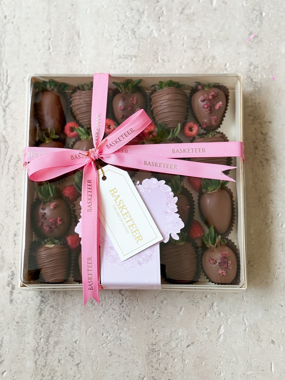 A premium Basketeer chocolate-covered strawberries gift box with pink sprinkles and ribbon, elegantly presented for luxury gifting in Bangkok.