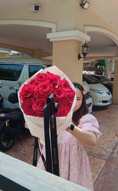 A stunning luxury red rose bouquet, beautifully wrapped in white and black ribbons, making it a perfect romantic gift for special occasions.