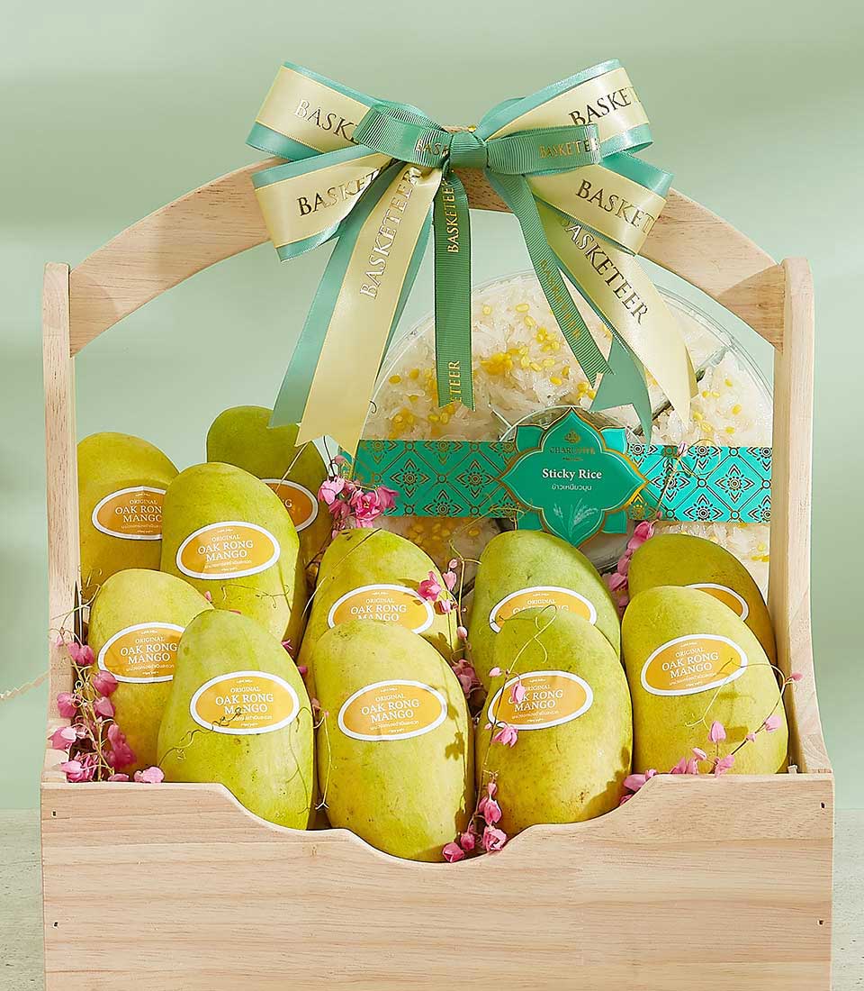 A wooden gift basket filled with multiple ripe mangoes, each labeled 