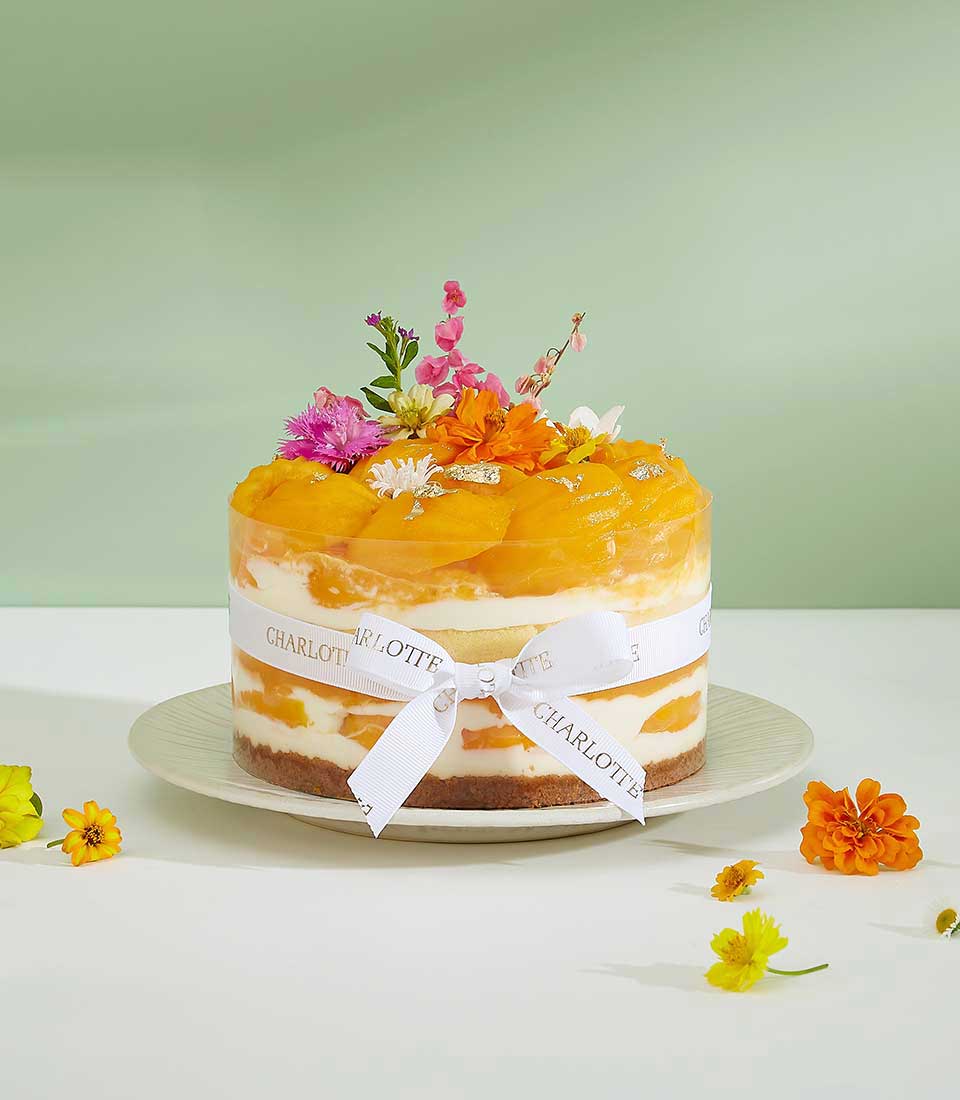 Indulge in the exquisite taste of our Floral Topped Mayongchid Layer Cake, a delightful bakery gift perfect for any celebration.