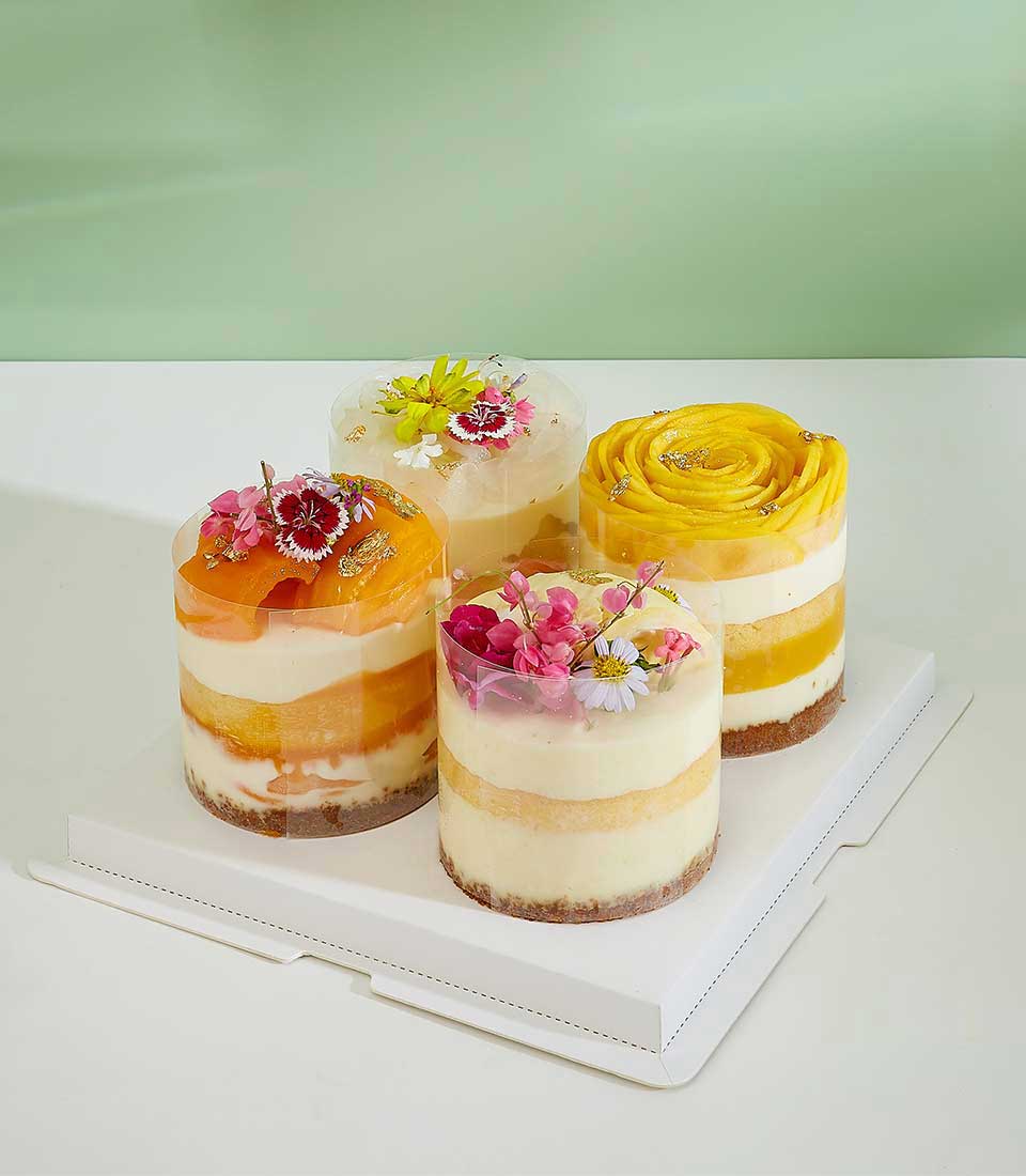 Explore our assortment of mixed tropical bliss mini layer cakes, a delightful mini cake bursting with exotic flavors.