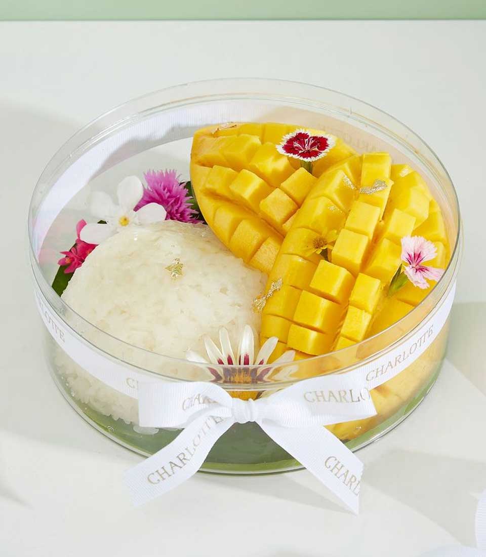 Indulge in the luxury of Thai mango sticky rice, a traditional dessert featuring sweet mangoes, sticky rice, and coconut cream.