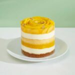 Indulge in the tropical bliss of our Swirled Mango Mini Layer Cake. Layers of moist cake infused with fresh mango flavors, topped with a swirl of creamy frosting.