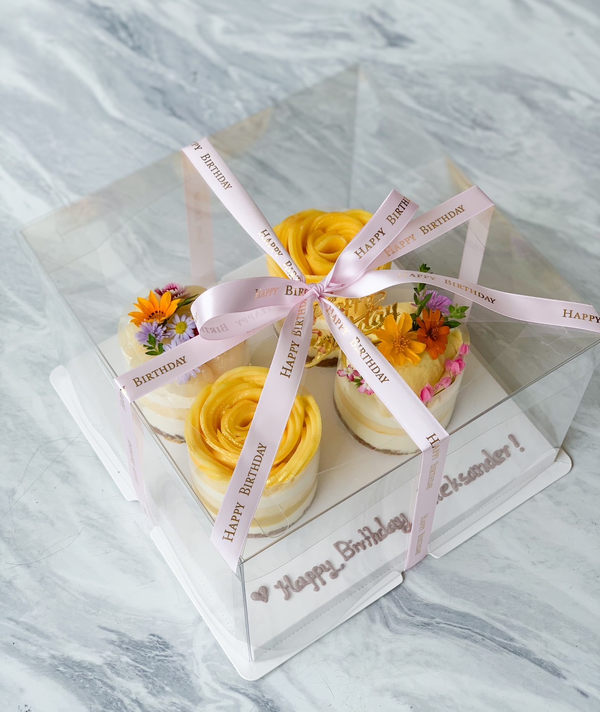 A clear box tied with a pink 