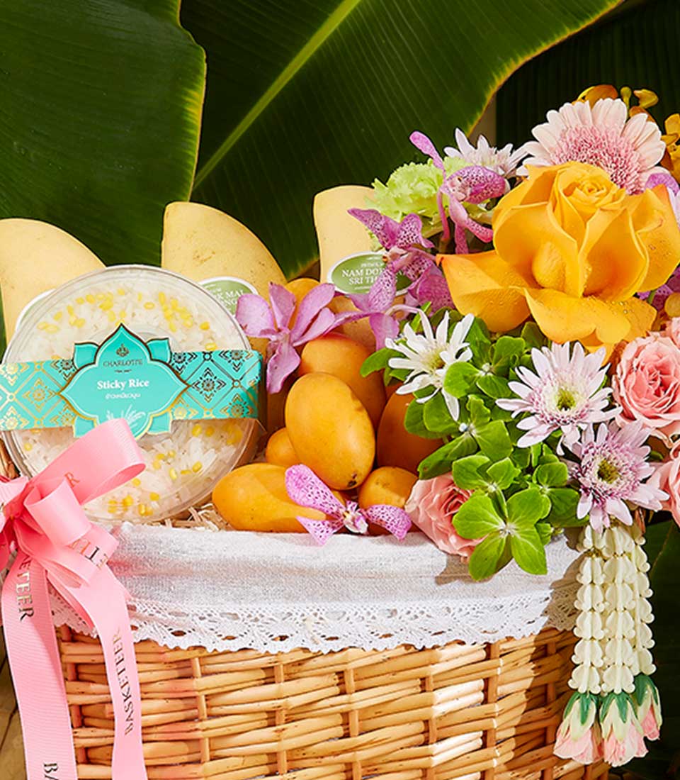 Experience the vibrant celebration of Thai New Year with our exquisite hamper featuring mango, mayongchid, stickyrice, and beautifully adorned with Thai flowers decorations.