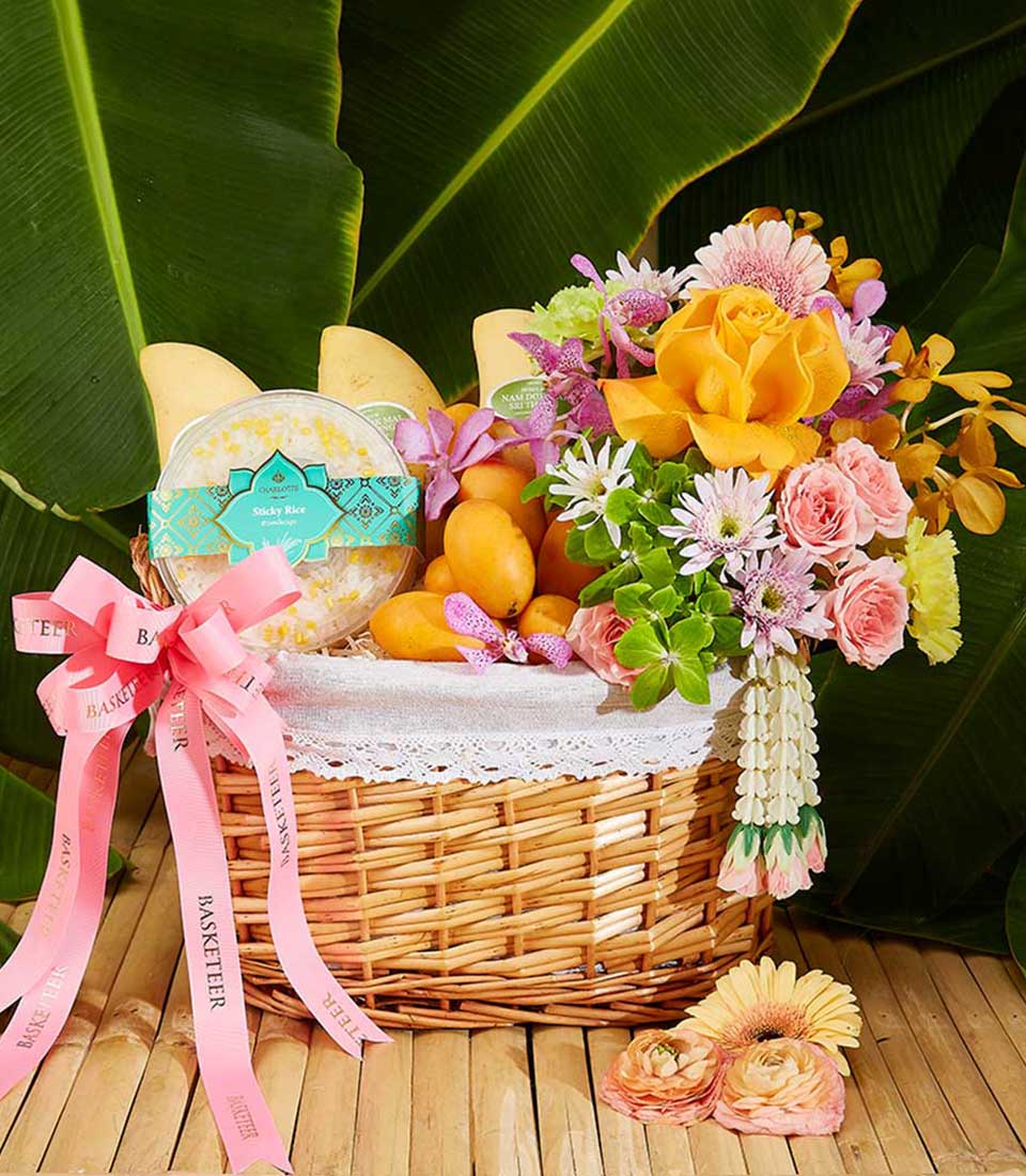 Experience the vibrant celebration of Thai New Year with our exquisite hamper featuring mango, mayongchid, stickyrice, and beautifully adorned with Thai flowers decorations.