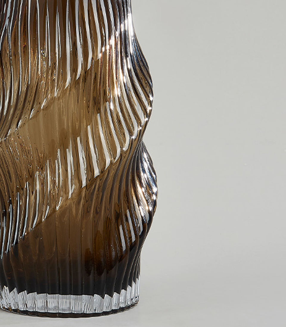 Close-up of Glass vase with a spiral pattern and smoky amber color.