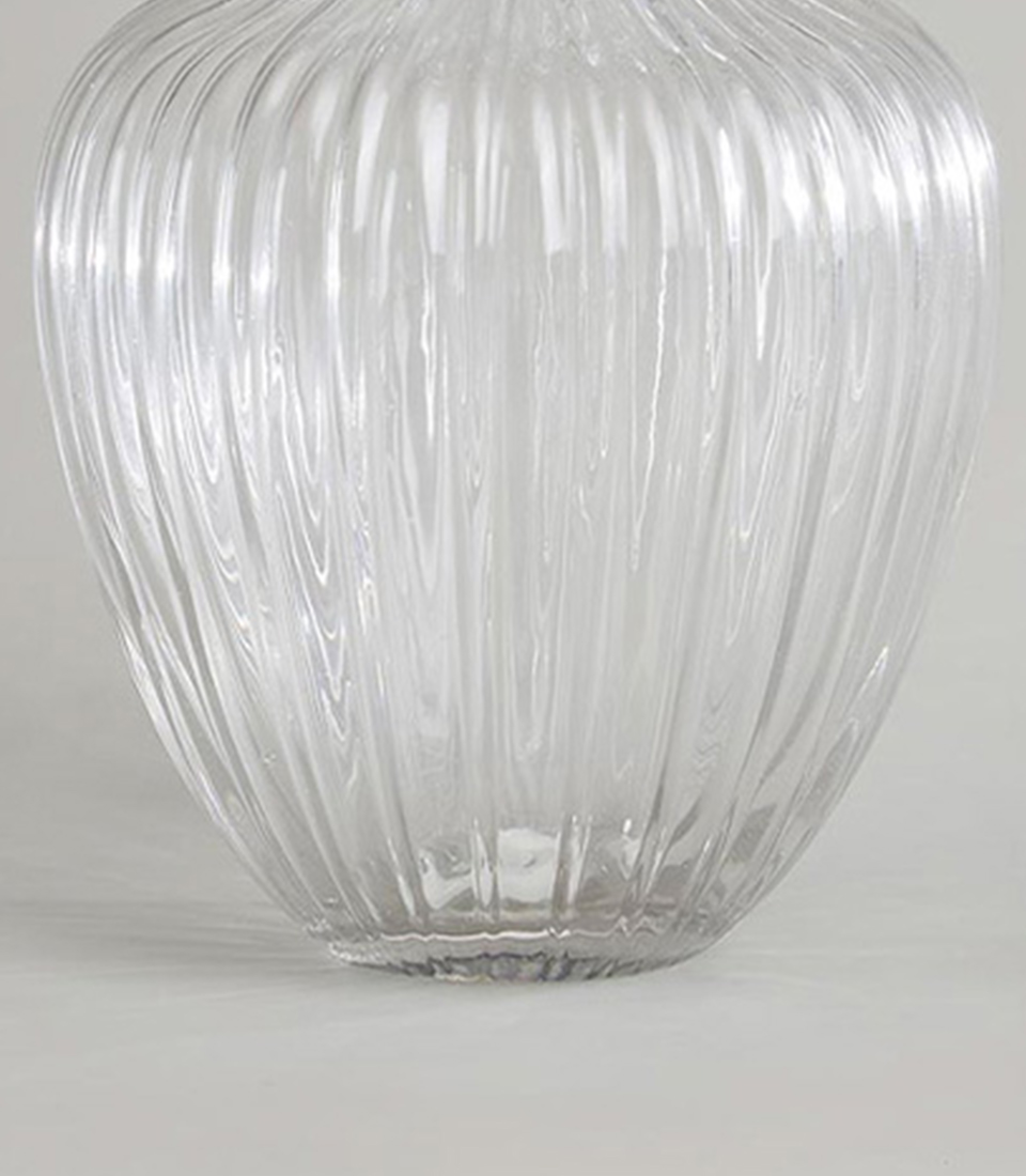 Close-up of clear glass vase with vertical ribbed design.